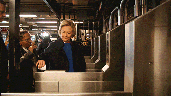 Hillary Clinton struggles with a New York City turnstile.